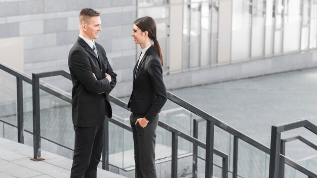 Businessman and businesswoman talking to each other