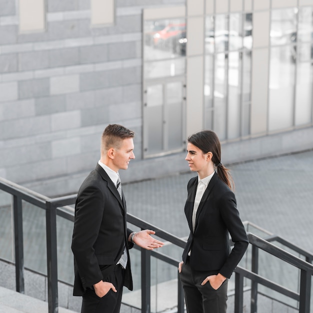 Businessman and businesswoman talking to each other