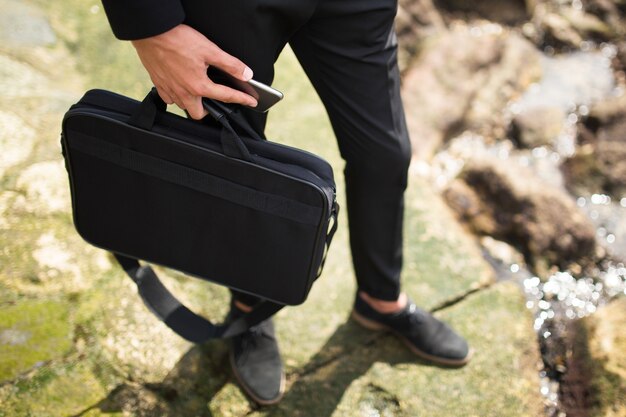 Businessman carrying briefcase and phone