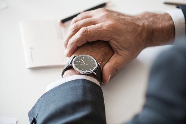 Businessman checking time on hand watch