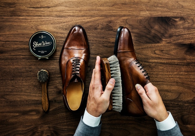 Businessman cleaning his shoes