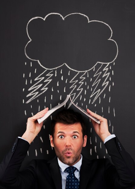 Businessman covering head from rain