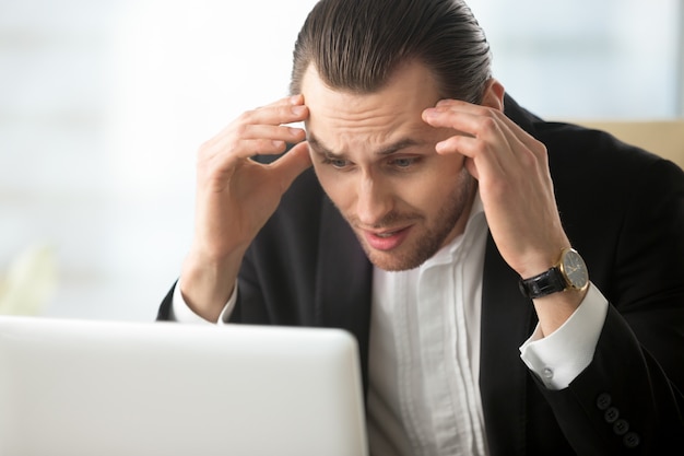 Businessman in despair because of bad news