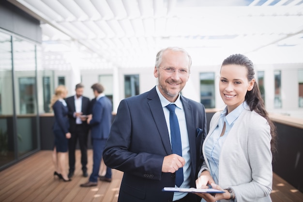 Businessman discussing over document with colleague