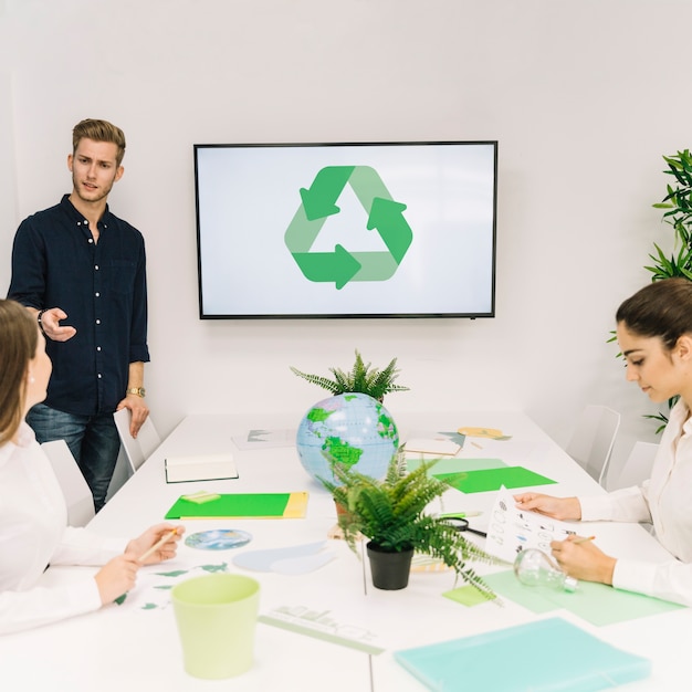 Businessman discussing recycle concept with his female colleague