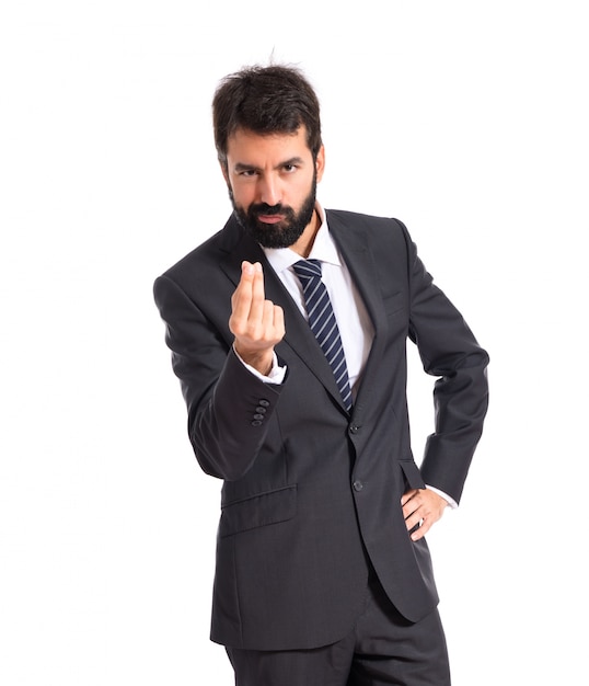 Businessman doing money gesture over white background