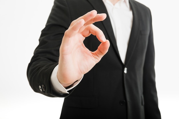 Free photo businessman doing ok gesture