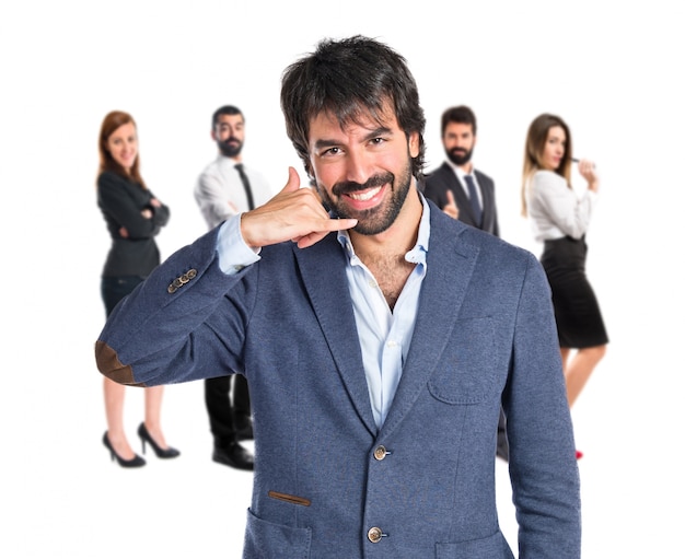 Businessman doing phone gesture over white background  