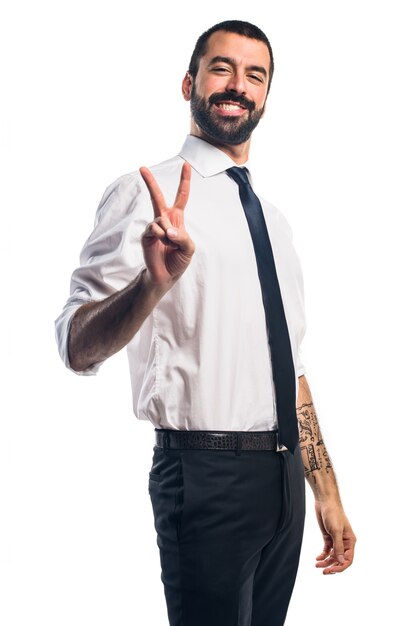 Businessman doing victory gesture