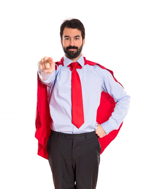 Businessman dressed like superhero pointing to the front