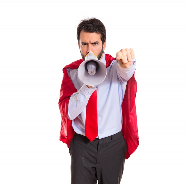 Businessman dressed like superhero shouting by megaphone