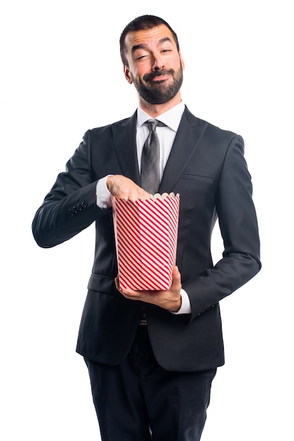 Businessman eating popcorns