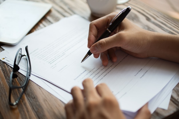 Free photo businessman examining papers at table