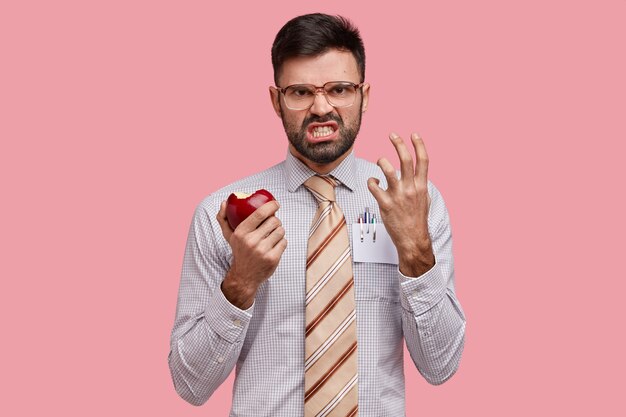Businessman in formal clothes holding apple