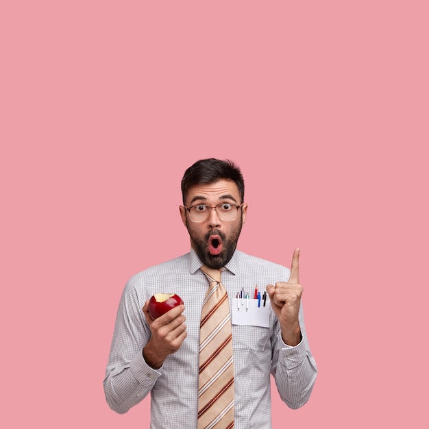 Businessman in formal clothes holding apple