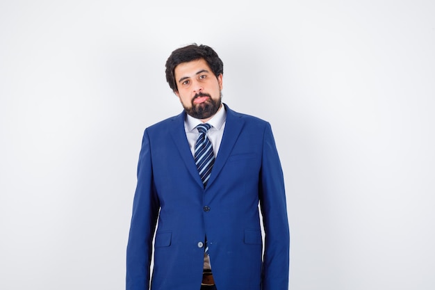 Businessman in formal suit standing straight and posing and looking serious , front view.