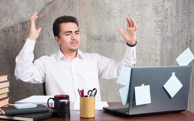 Businessman got sad news regarding to his business at the office desk.