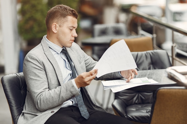 Businessman. Guy in a suit. Male with a documents.