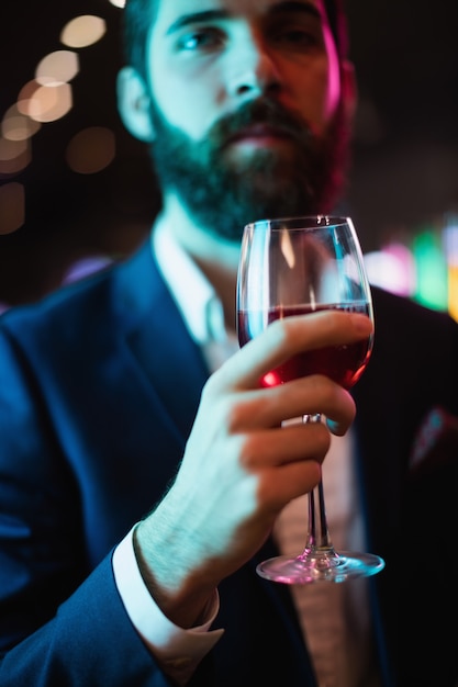 Businessman having glass of wine