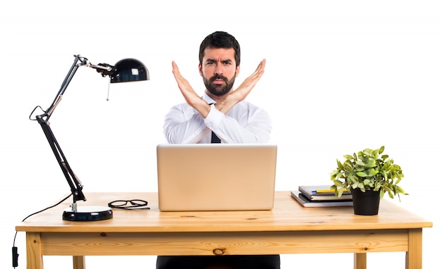Free photo businessman in his office doing no gesture