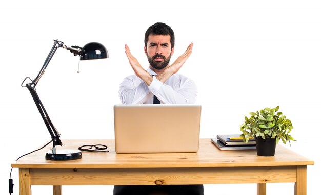 Businessman in his office doing NO gesture