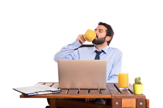 Businessman in his office drinking coffee