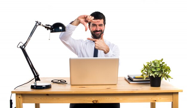 Businessman in his office focusing with his fingers