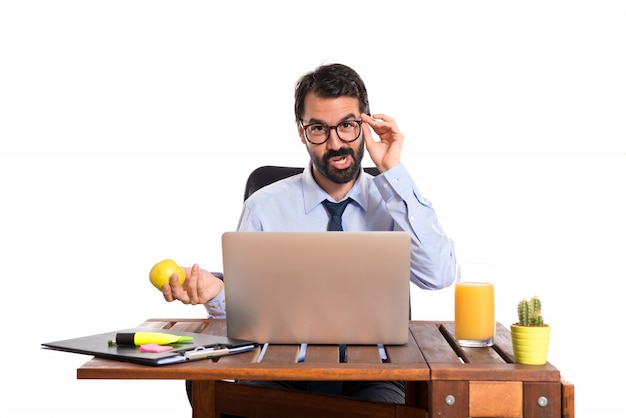 Businessman in his office holding an apple