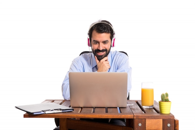 Free photo businessman in his office listening music