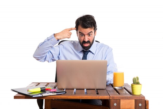 Businessman in his office making crazy gesture