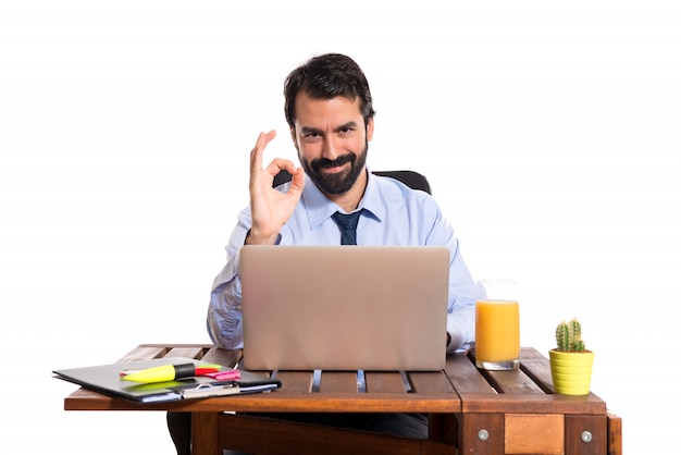 Businessman in his office making Ok sign