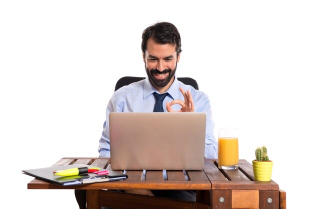 Businessman in his office making Ok sign