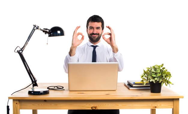 Businessman in his office making OK sign