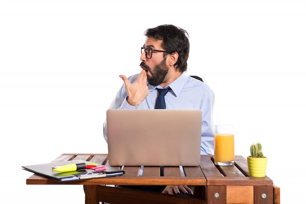 Businessman in his office  making suicide gesture