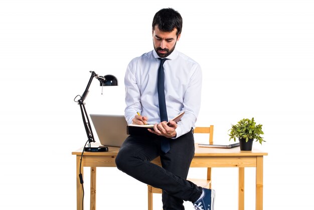 Businessman in his office reading notes