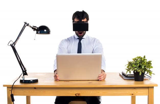 Businessman in his office using VR glasses