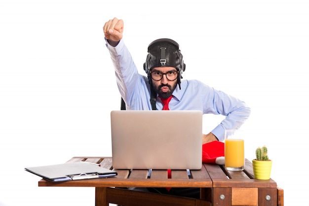 Businessman in his office with pilot hat