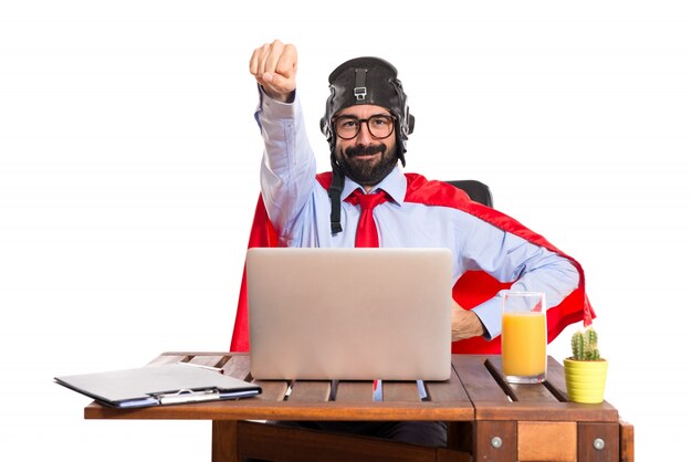 Businessman in his office with pilot hat