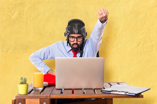 Businessman in his office with pilot hat