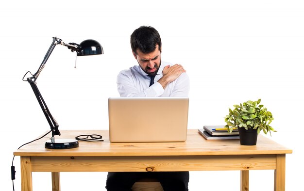 Businessman in his office with shoulder pain