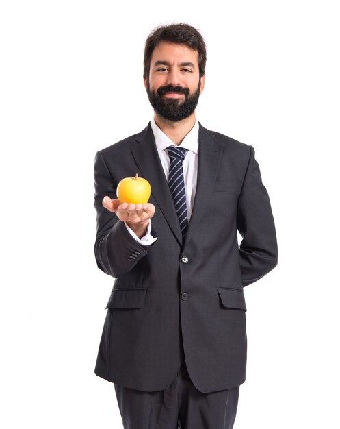 Businessman holding an apple over white