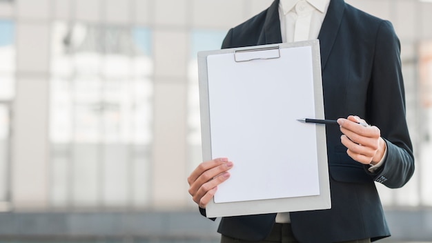 Businessman holding blank clipboard