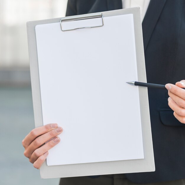 Businessman holding blank clipboard