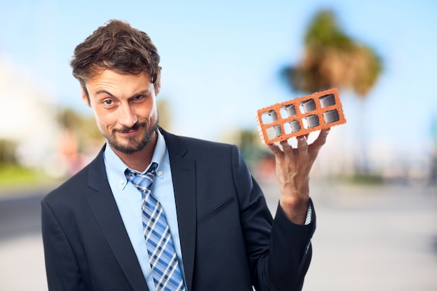 Businessman holding a brick