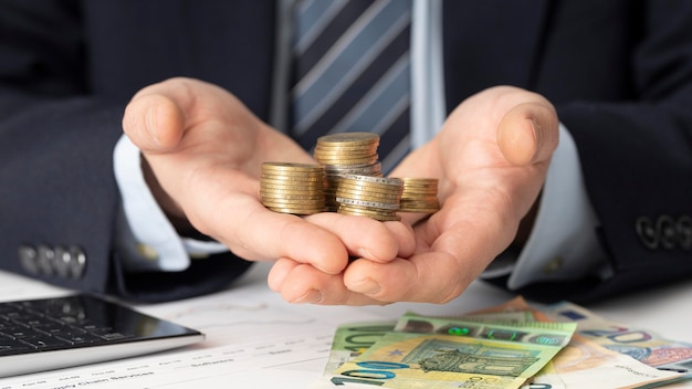 Businessman holding a bunch of coins