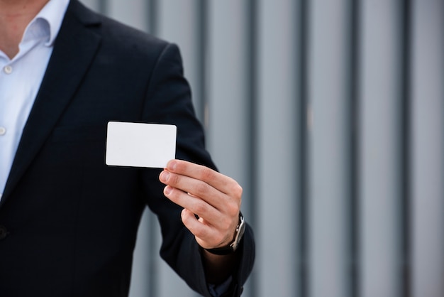 Businessman holding card close-up