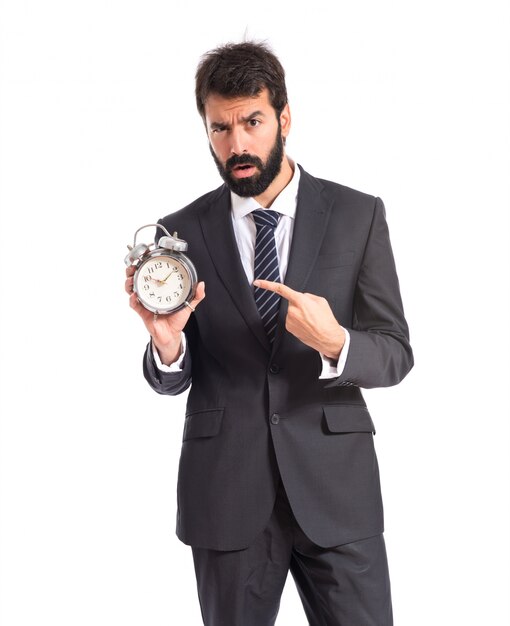 Businessman holding a clock over white background