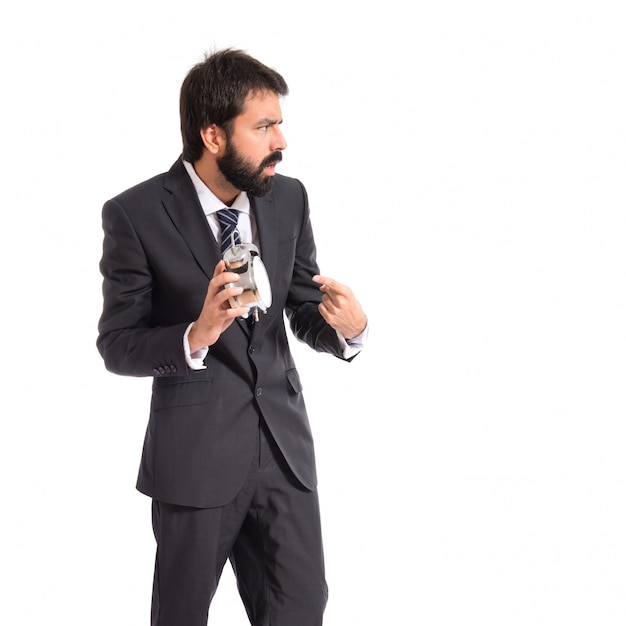 Businessman holding a clock over white background
