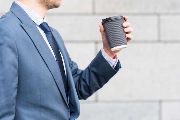 Businessman holding coffee cup