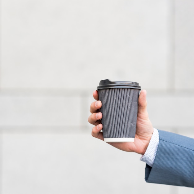 Businessman holding coffee cup